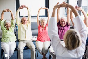 Seniors doing exercises in a retirement home